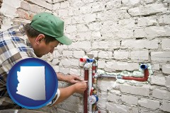 arizona map icon and a plumbing contractor installing new water supply lines