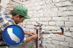 california map icon and a plumbing contractor installing new water supply lines