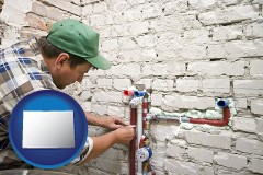 colorado map icon and a plumbing contractor installing new water supply lines