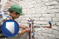 nevada map icon and a plumbing contractor installing new water supply lines