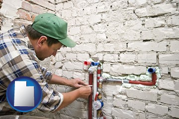 a plumbing contractor installing new water supply lines - with Utah icon